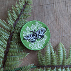 The Iron-on patch | polyphemus moth with lichen - green by ilikesara | art + goods features an embroidered moth on green, white detailing, and is perfect for adding unique insect flair to any garment.