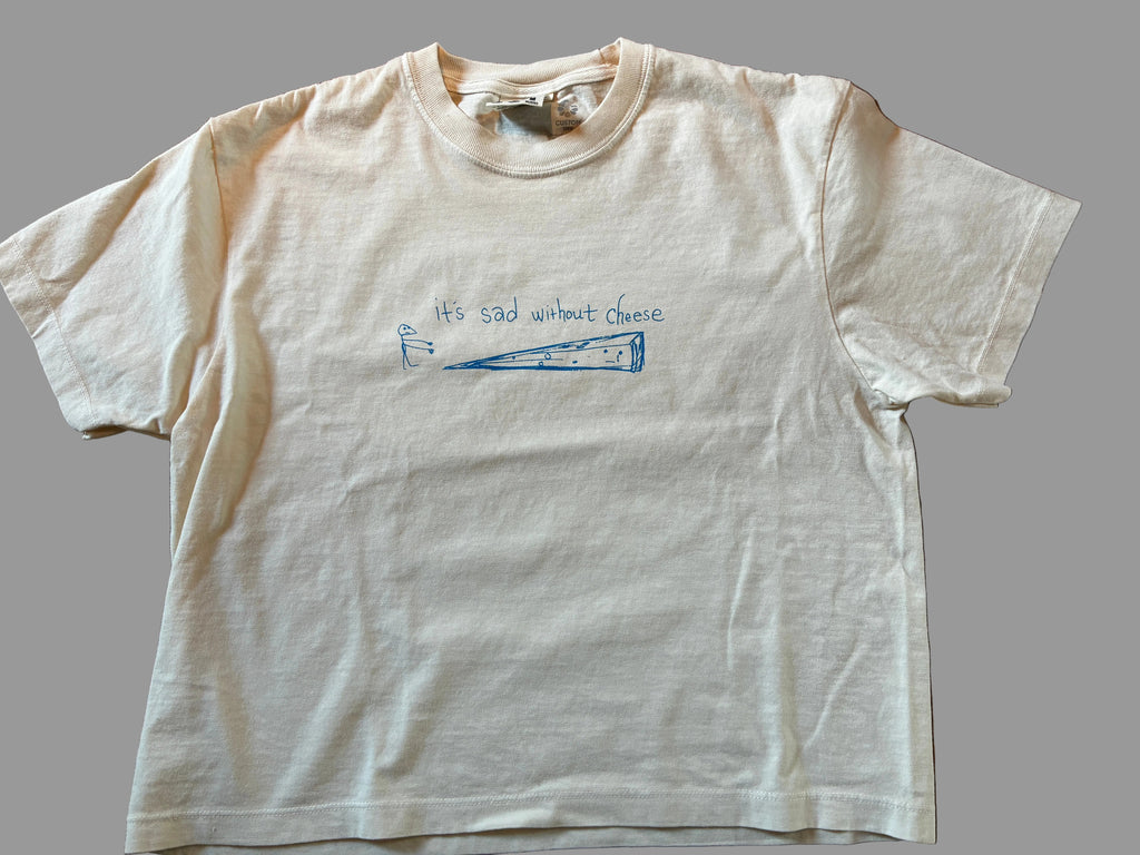 White t-shirt with blue text and graphic on a grey surface