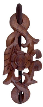 The Benjamin International Wooden Hair Pin showcases an intricate floral and leaf design, featuring a central flower motif with curling vine-like shapes.