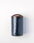 The Handblown Hammered Glass Canisters: Smoke / Medium by Creative Women features a textured glass body with an airtight lid, offering stylish storage, shown against a white background.