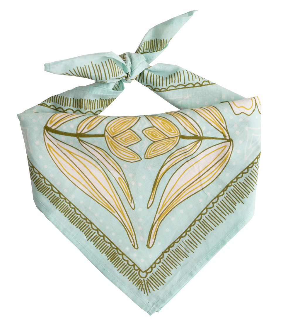 The No. 012 Eliza Bandana by Handker Bandanas features a light blue floral design with gold and olive green abstract accents, hand screen-printed on premium cotton and tied in a knot against a white background.