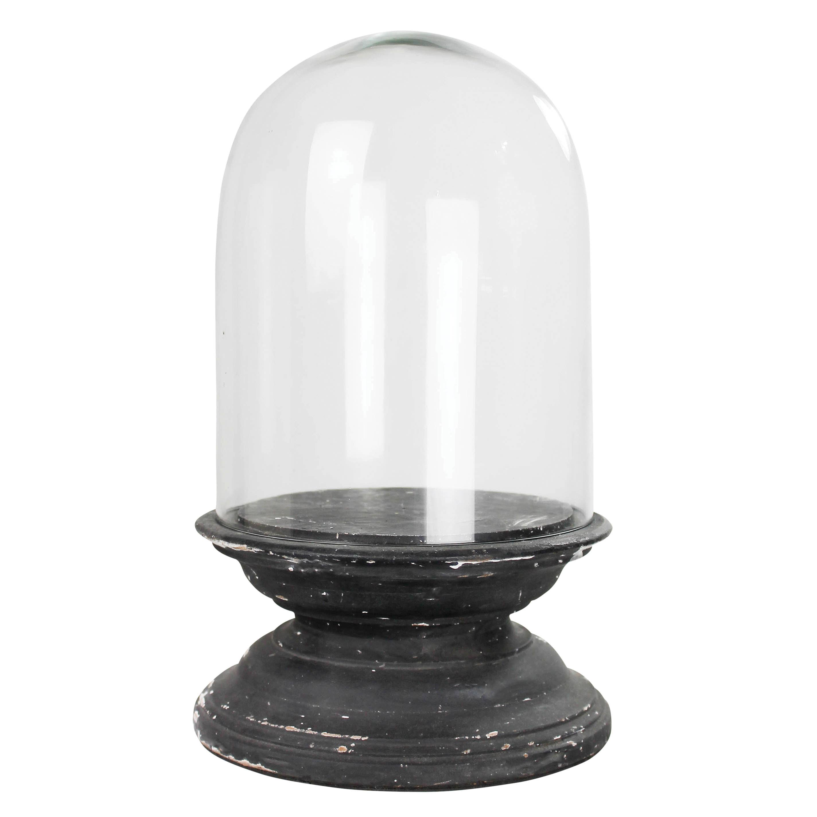 The HomArt Arroyo Dome with Wood Base, Black - Lrg features a clear, rounded glass dome atop a distressed black wood and glass base with visible wear and chipping, creating a striking display against any white background.