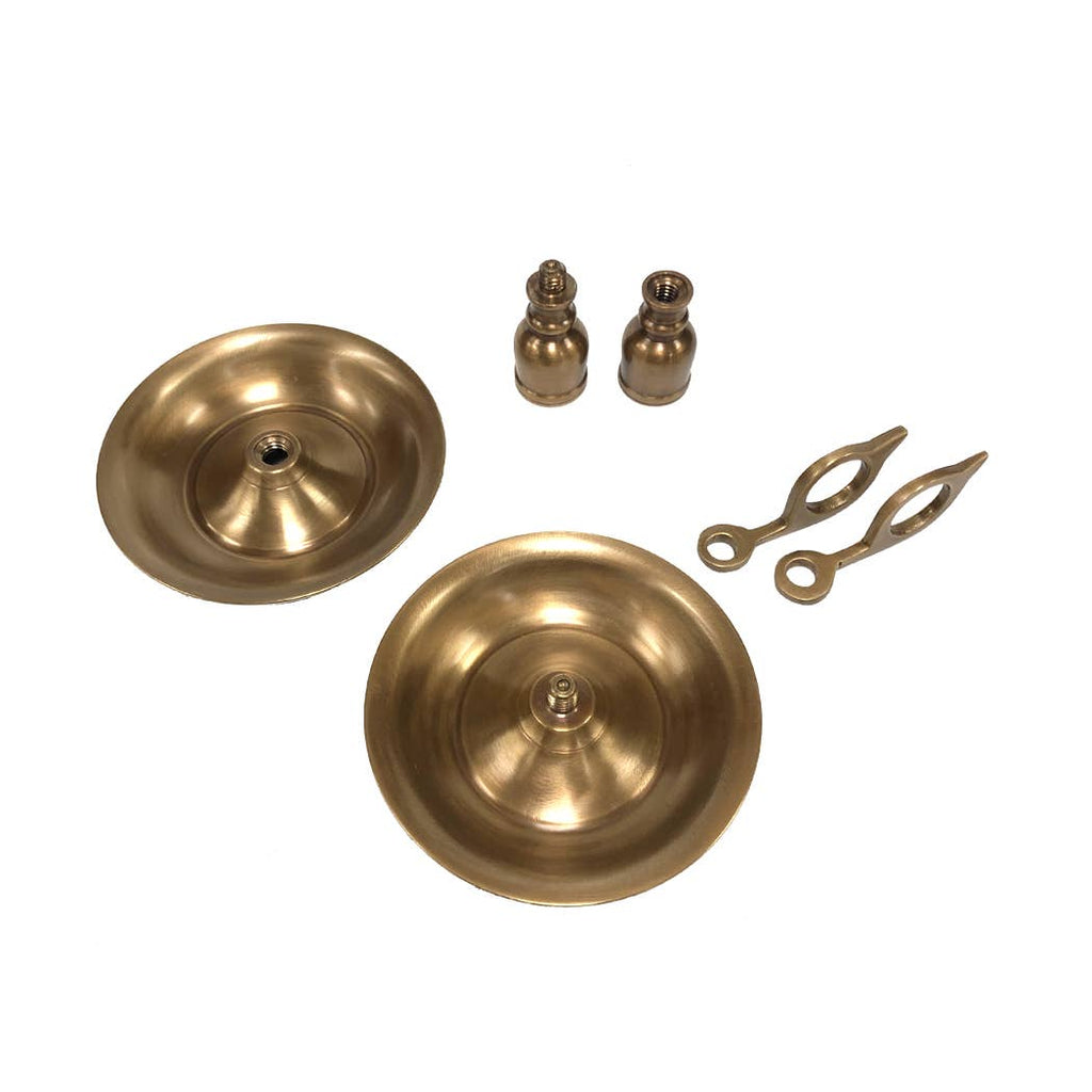The Brighton Bun Traveling Chamberstick Set by Madison Bay Co. - Historical Home Decor Reproductions is displayed on a white background, showcasing its antique-inspired design and classic brass finish.