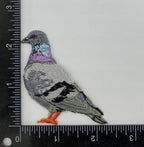 The Wholesale Applique Rock Dove Pigeon, Birds, Iron on Patch features purple, blue, gray, and black embroidery and is shown on a white background beside rulers that indicate it measures about 2 to 3 inches tall and wide.