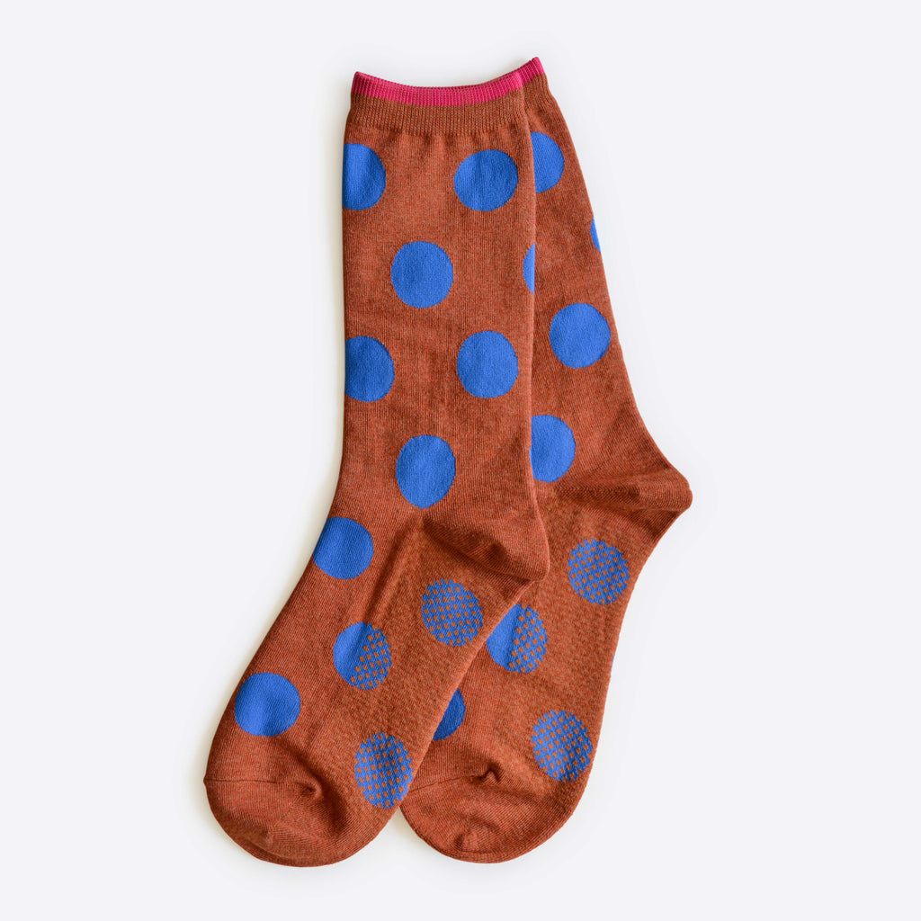 Panhandle Polka Dot Crew Socks by Hooray Sock Co. feature brown crew-length cotton-spandex with large blue polka dots and pink trim, shown laid flat on a light background.