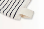 Close-up of The Loomia Turkish Cotton Striped Terry Hand Towel in cream with black stripes and a corner loop, shown on a white background—perfect for those seeking highly absorbent towels.