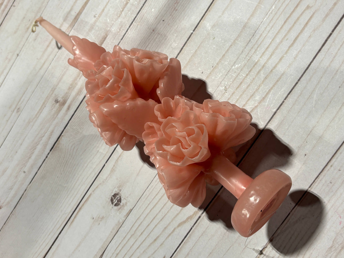 Light pink handmade Rose Quartz Large Oaxaca Marigold Candle in a beeswax taper shape, embellished with carved floral blooms and a circular base.