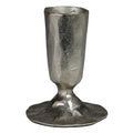 The HomArt Jon Candlestick in nickel features a rough, silver finish with a wide, uneven base and hammered surface, creating the look of a handcrafted piece with rustic charm.