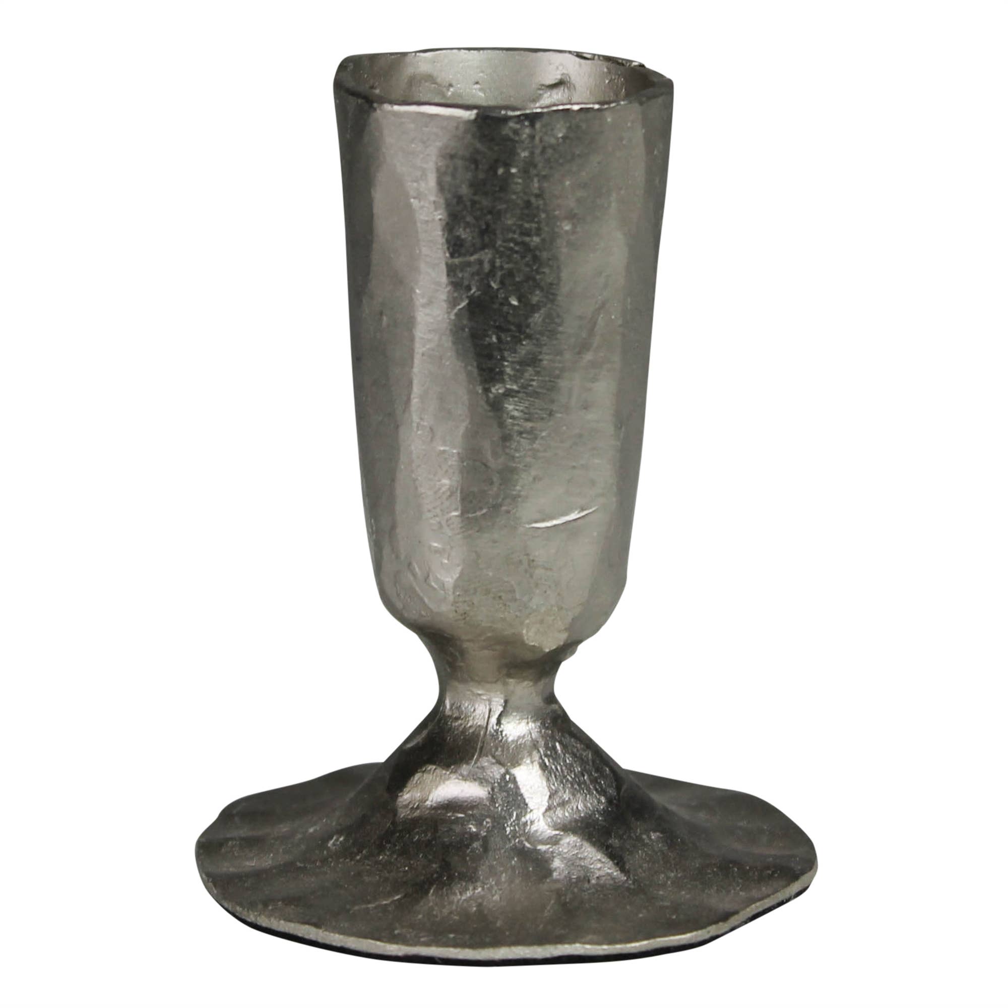 The HomArt Jon Candlestick in nickel features a rough, silver finish with a wide, uneven base and hammered surface, creating the look of a handcrafted piece with rustic charm.