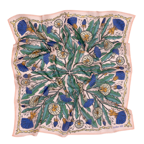 The 34" Dandy Wild Rag Bandana by Handker Bandanas is a square silk scarf with a botanical print of dandelions, green leaves, and blue thistles on pale pink, bordered with wavy lines and inspired by classic bandanas. Fabric has a slightly rumpled look.