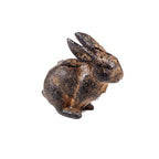 The Vagabond Vintage Small Cast Iron Rabbit is a rustic, dark brown sculpture featuring an upright rabbit with ears pointed back, shown in side profile against a white background.