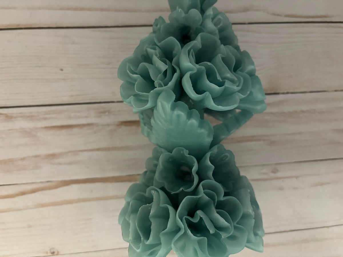Beeswax Large Sage Oaxaca Marigold candle, handmade in a sage green color and shaped like a cluster of flowers.