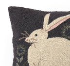 The Hare with Sunflowers Hook Pillow by Warren Kimble for Peking Handicraft features a hooked wool design of a white rabbit with pink in its ear on a dark background with green, showing only half the pillow and rabbit.